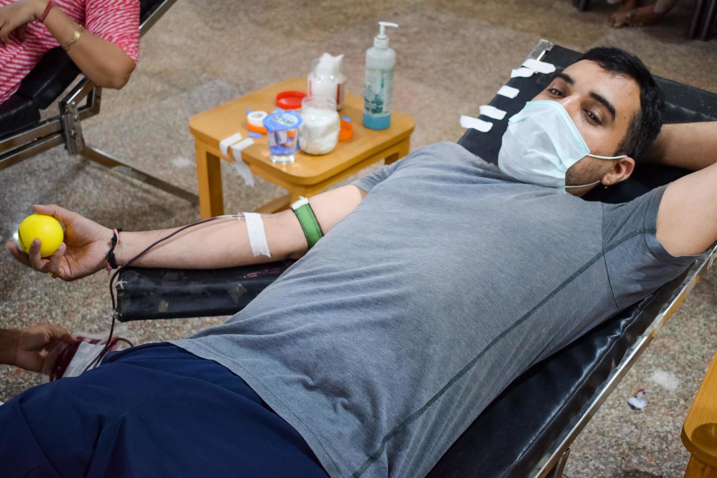 Delhi, India, June 19 2022 - Blood donor at Blood donation camp held at Balaji Temple, Vivek Vihar, Delhi, India, Image for World blood donor day on June 14 every year, Blood Donation Camp at Temple photo