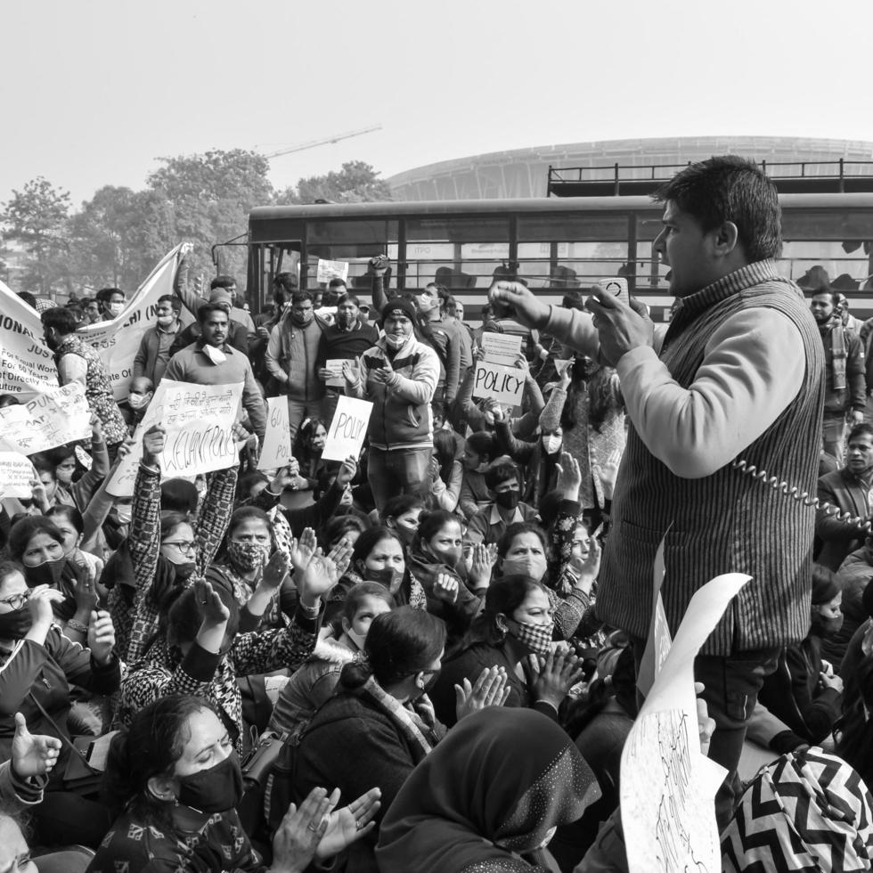 Delhi, India December 25 2021 - Delhi Contractual Guest Teachers with posters, flags and graffitis protesting against Delhi AAP Government for making policy, Delhi Teacher protesting Black and White photo