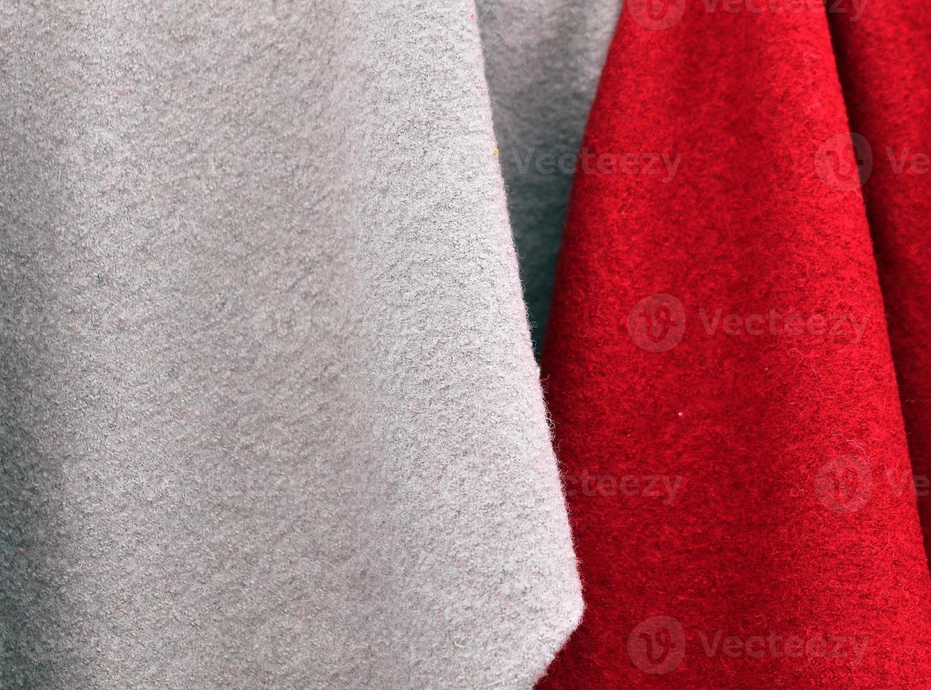 Detailed close up view on samples of cloth and fabrics in different colors found at a fabrics market photo