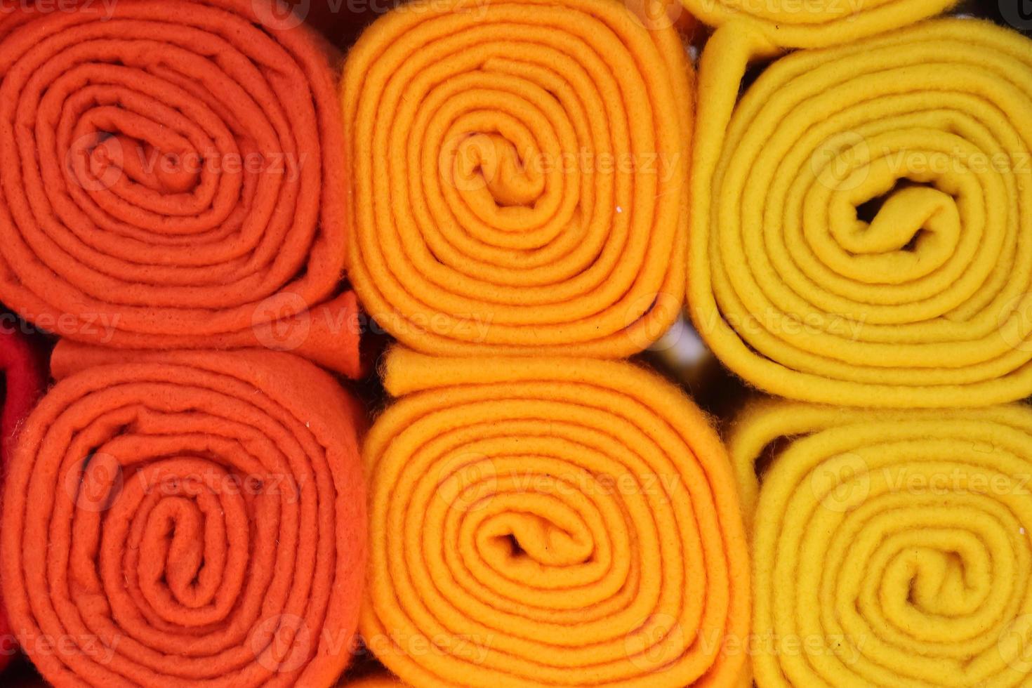 Detailed close up view on samples of cloth and fabrics in different colors found at a fabrics market photo