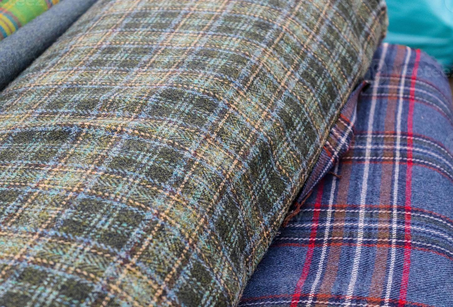 Detailed close up view on samples of cloth and fabrics in different colors found at a fabrics market photo