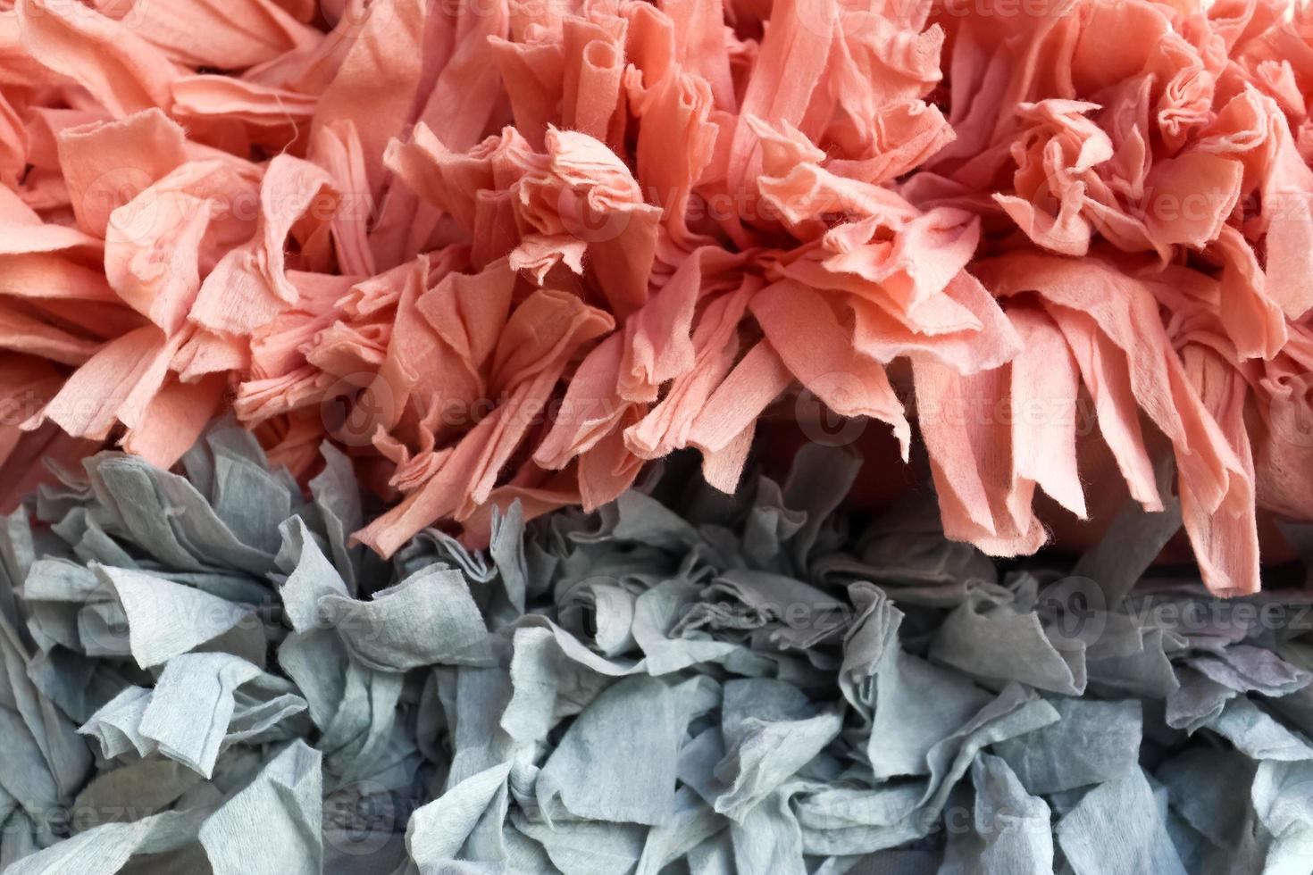 Detailed close up view on samples of cloth and fabrics in different colors found at a fabrics market photo