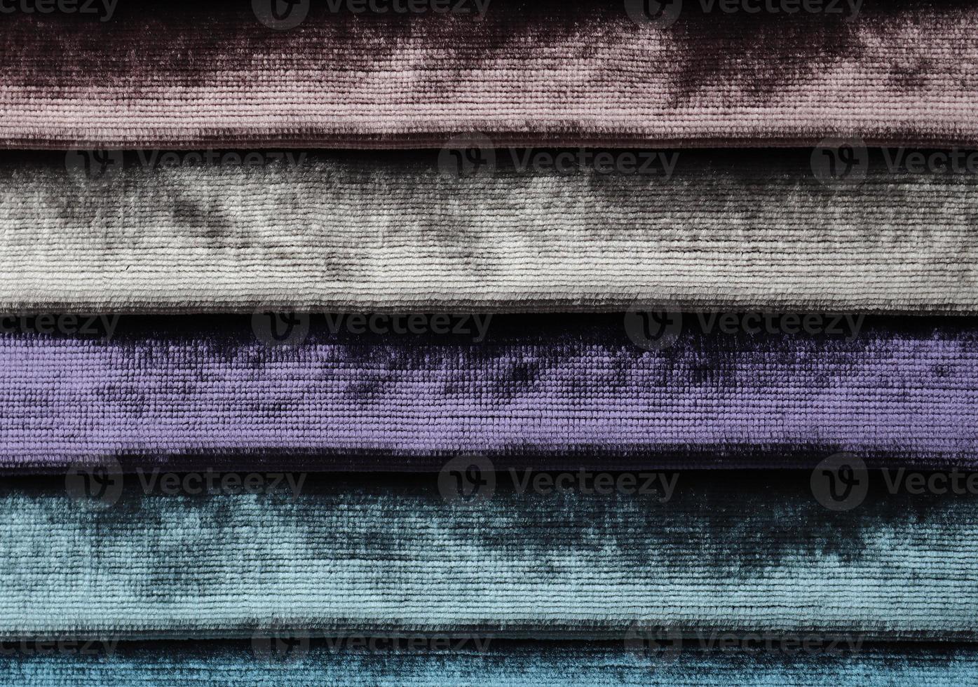 Detailed close up view on samples of cloth and fabrics in different colors found at a fabrics market photo