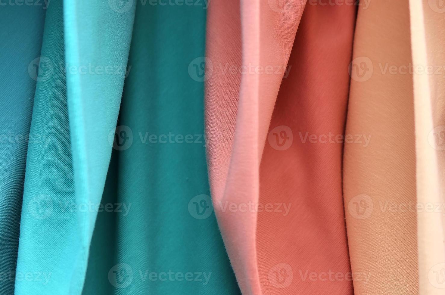 Detailed close up view on samples of cloth and fabrics in different colors found at a fabrics market photo