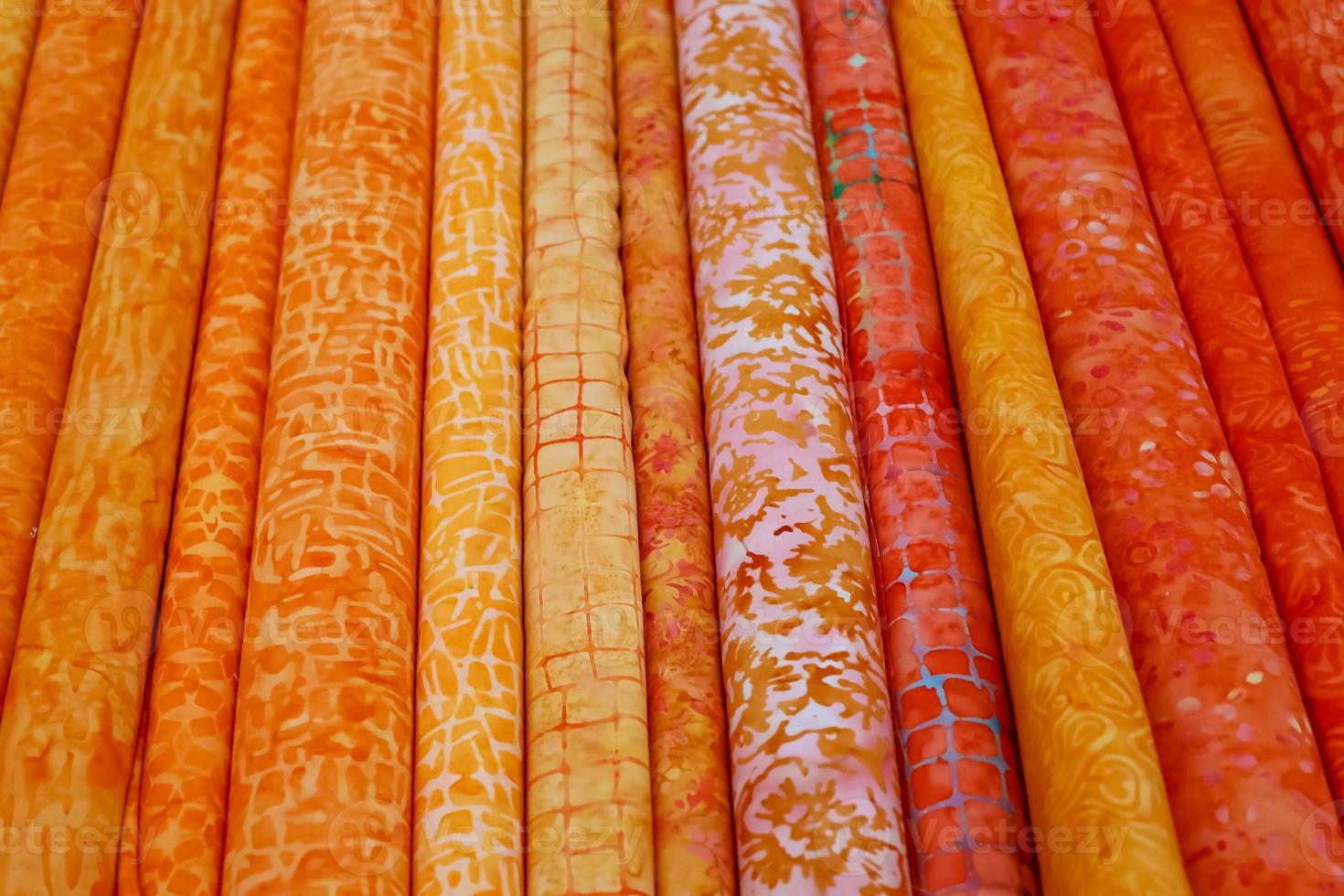 Detailed close up view on samples of cloth and fabrics in different colors found at a fabrics market photo