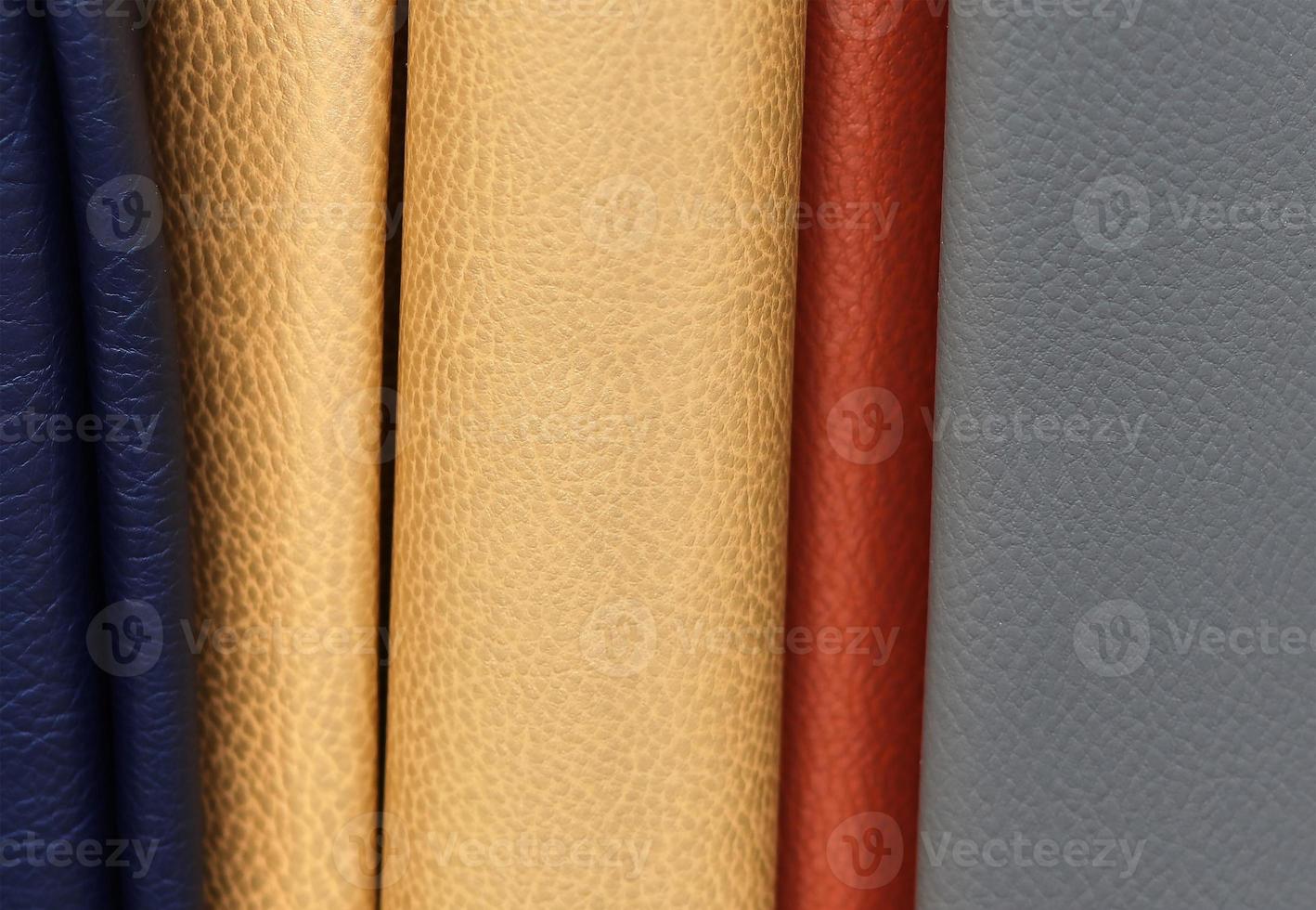 Detailed close up view on samples of cloth and fabrics in different colors found at a fabrics market photo