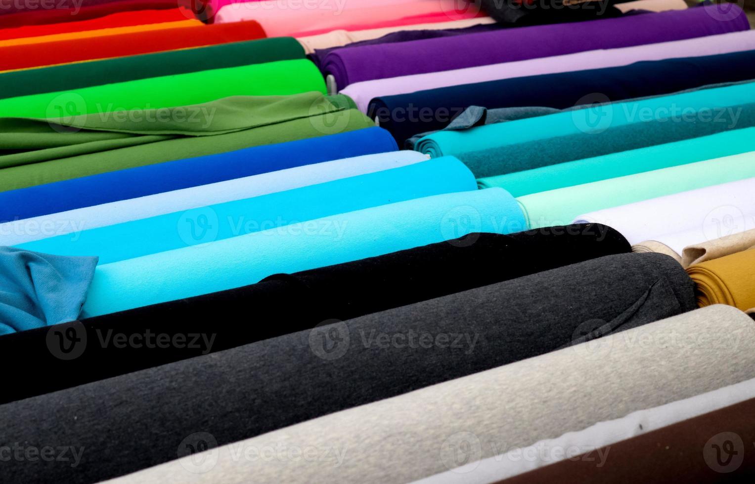 Detailed close up view on samples of cloth and fabrics in different colors found at a fabrics market photo