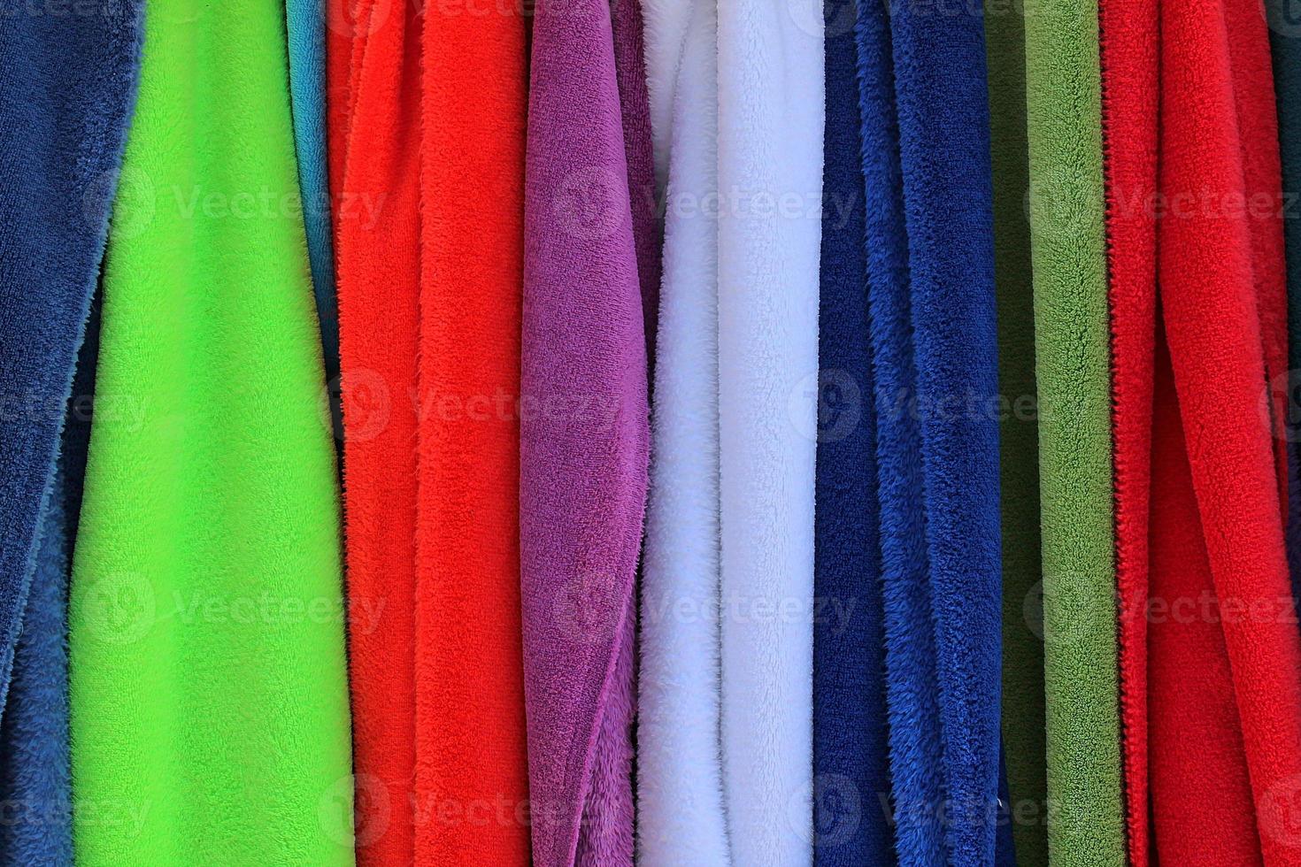 Detailed close up view on samples of cloth and fabrics in different colors found at a fabrics market photo