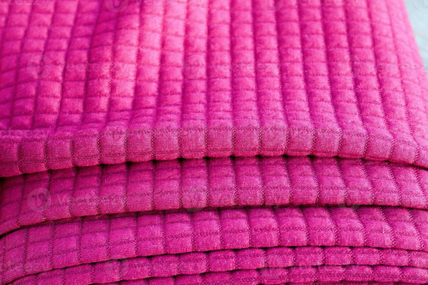 Detailed close up view on samples of cloth and fabrics in different colors found at a fabrics market photo