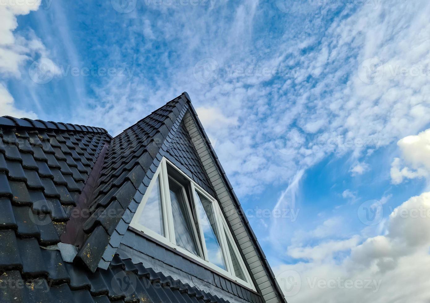 Open roof window in velux style with black roof tiles. photo