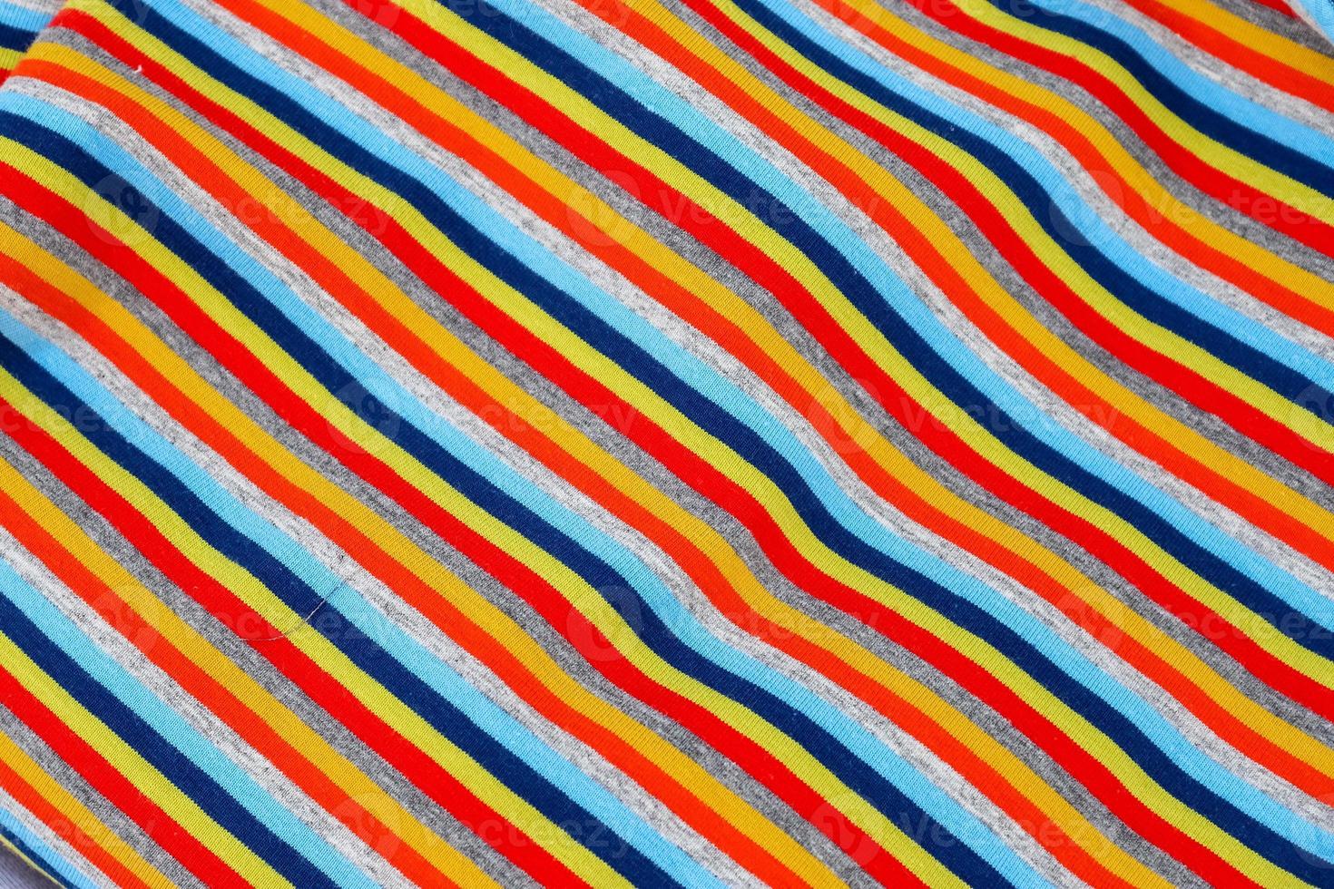 Detailed close up view on samples of cloth and fabrics in different colors found at a fabrics market photo
