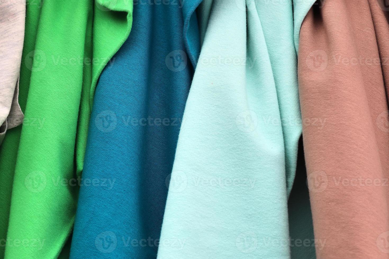Detailed close up view on samples of cloth and fabrics in different colors found at a fabrics market photo