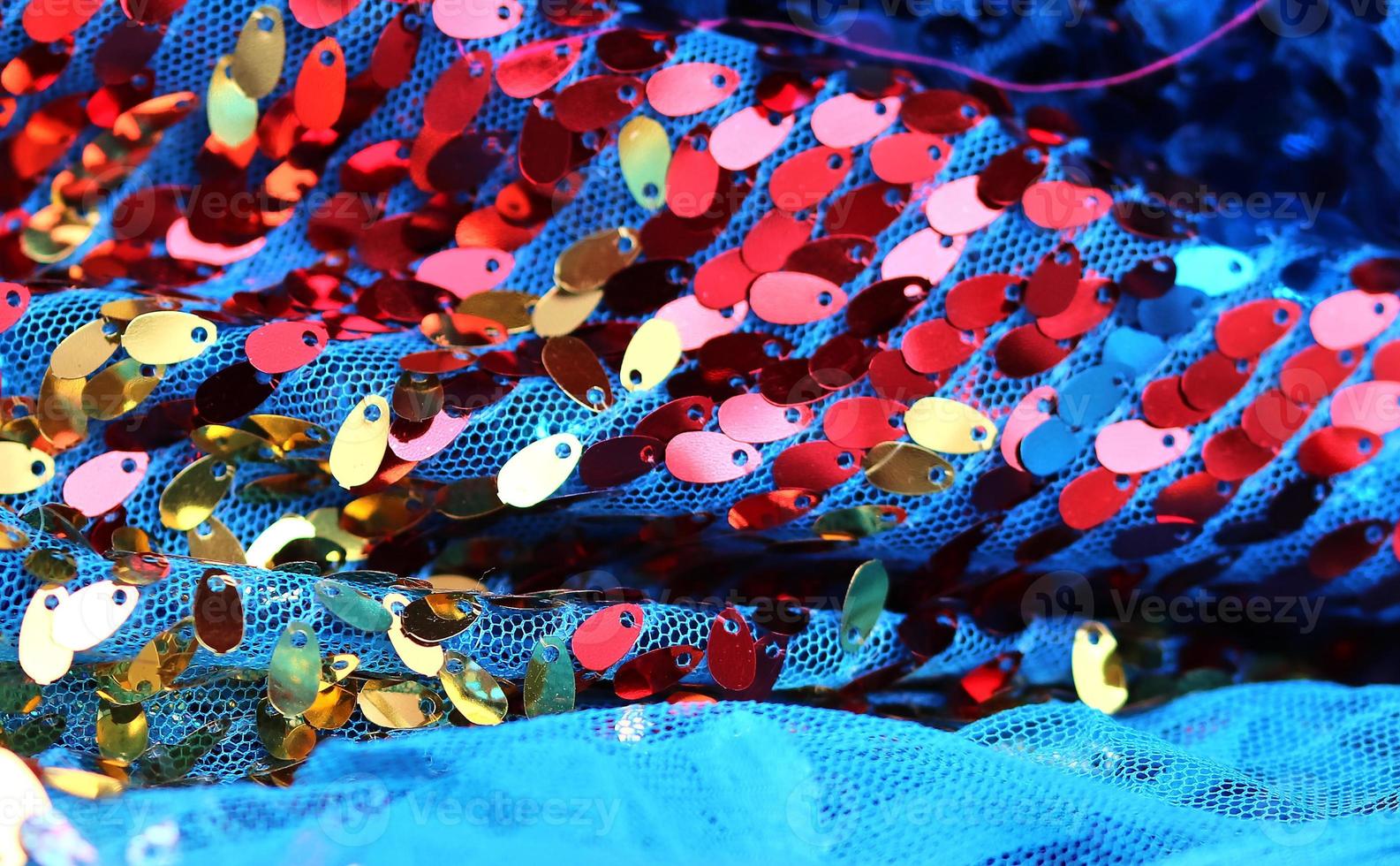 Detailed close up view on samples of cloth and fabrics in different colors found at a fabrics market photo