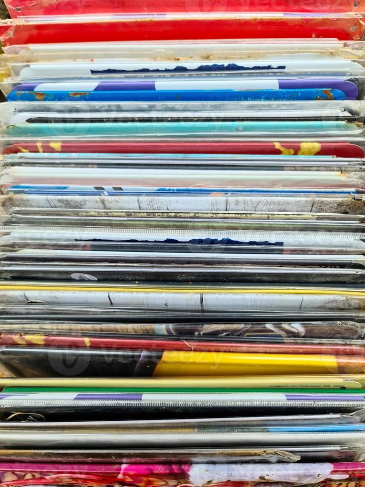 Numerous vintage signs and vinyl records in a box seen from above. photo