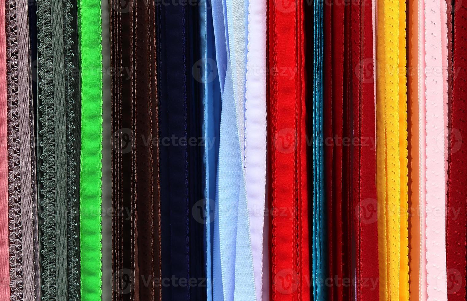 Detailed close up view on samples of cloth and fabrics in different colors found at a fabrics market photo