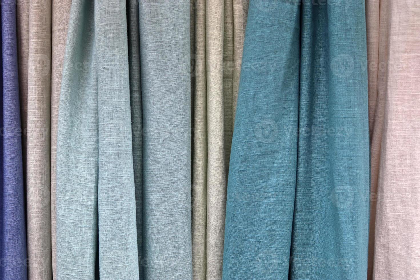 Detailed close up view on samples of cloth and fabrics in different colors found at a fabrics market photo