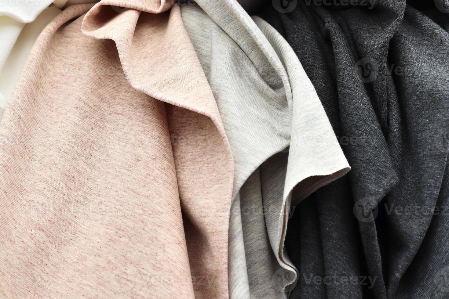 Detailed close up view on samples of cloth and fabrics in different colors found at a fabrics market photo