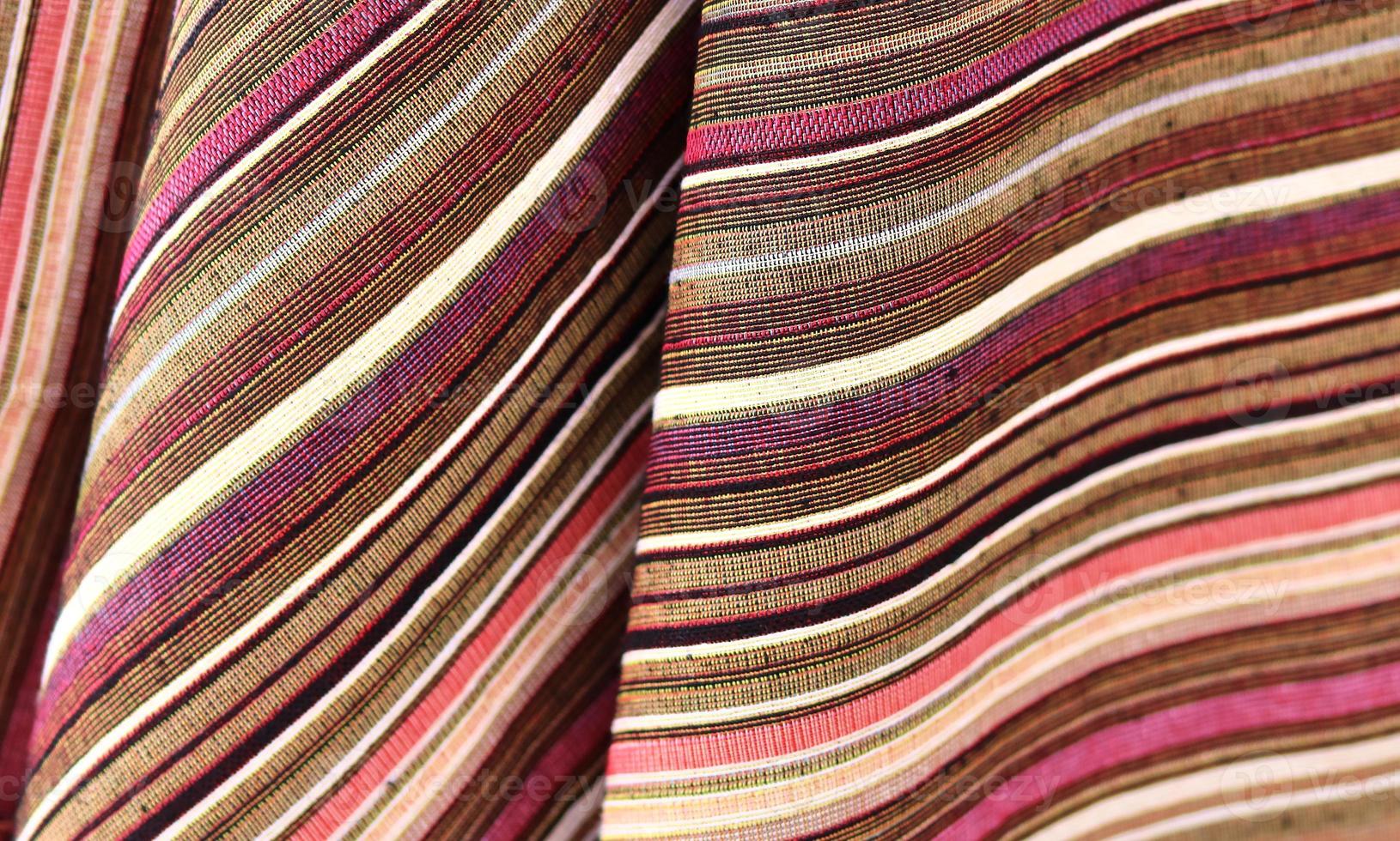Detailed close up view on samples of cloth and fabrics in different colors found at a fabrics market photo