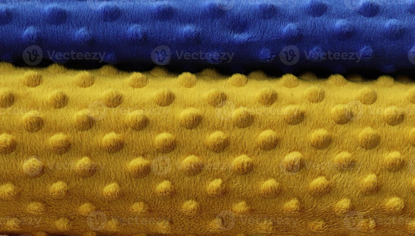Detailed close up view on samples of cloth and fabrics in different colors found at a fabrics market photo