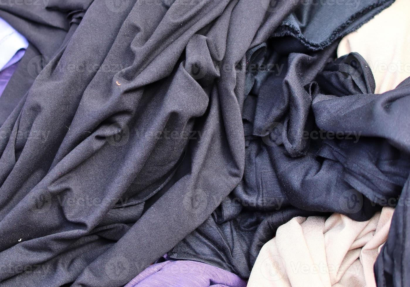 Detailed close up view on samples of cloth and fabrics in different colors found at a fabrics market photo