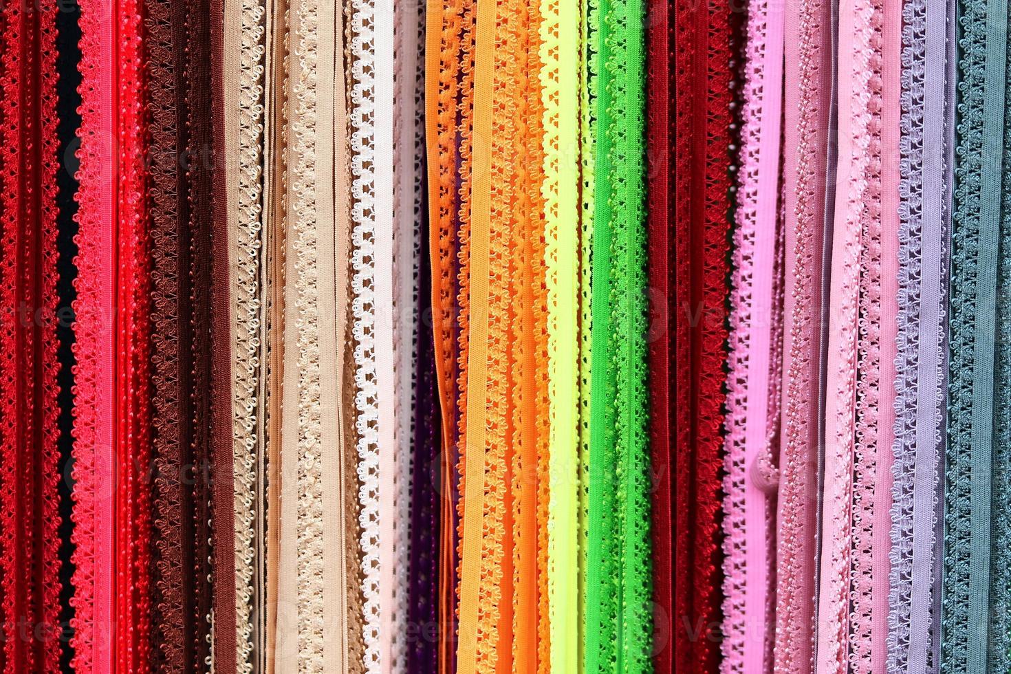 Detailed close up view on samples of cloth and fabrics in different colors found at a fabrics market photo