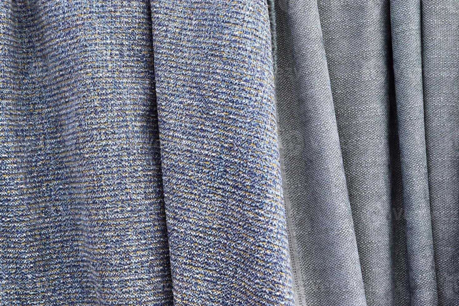 Detailed close up view on samples of cloth and fabrics in different colors found at a fabrics market photo