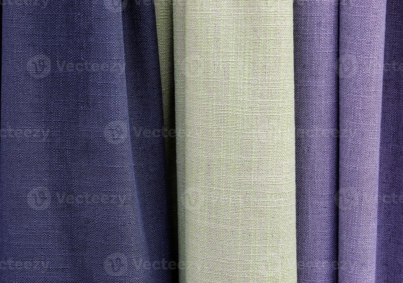 Detailed close up view on samples of cloth and fabrics in different colors found at a fabrics market photo