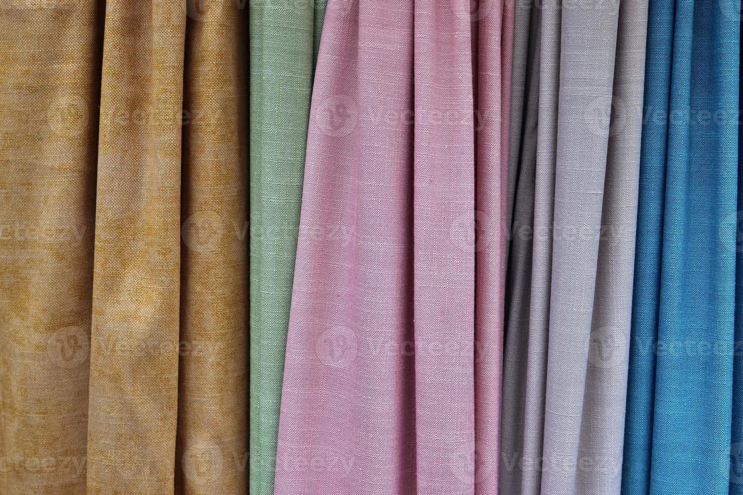 Detailed close up view on samples of cloth and fabrics in different colors found at a fabrics market photo