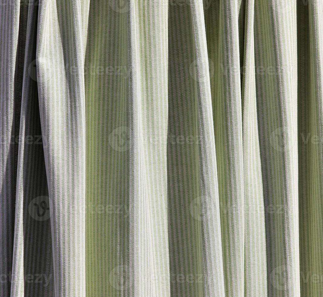 Detailed close up view on samples of cloth and fabrics in different colors found at a fabrics market photo