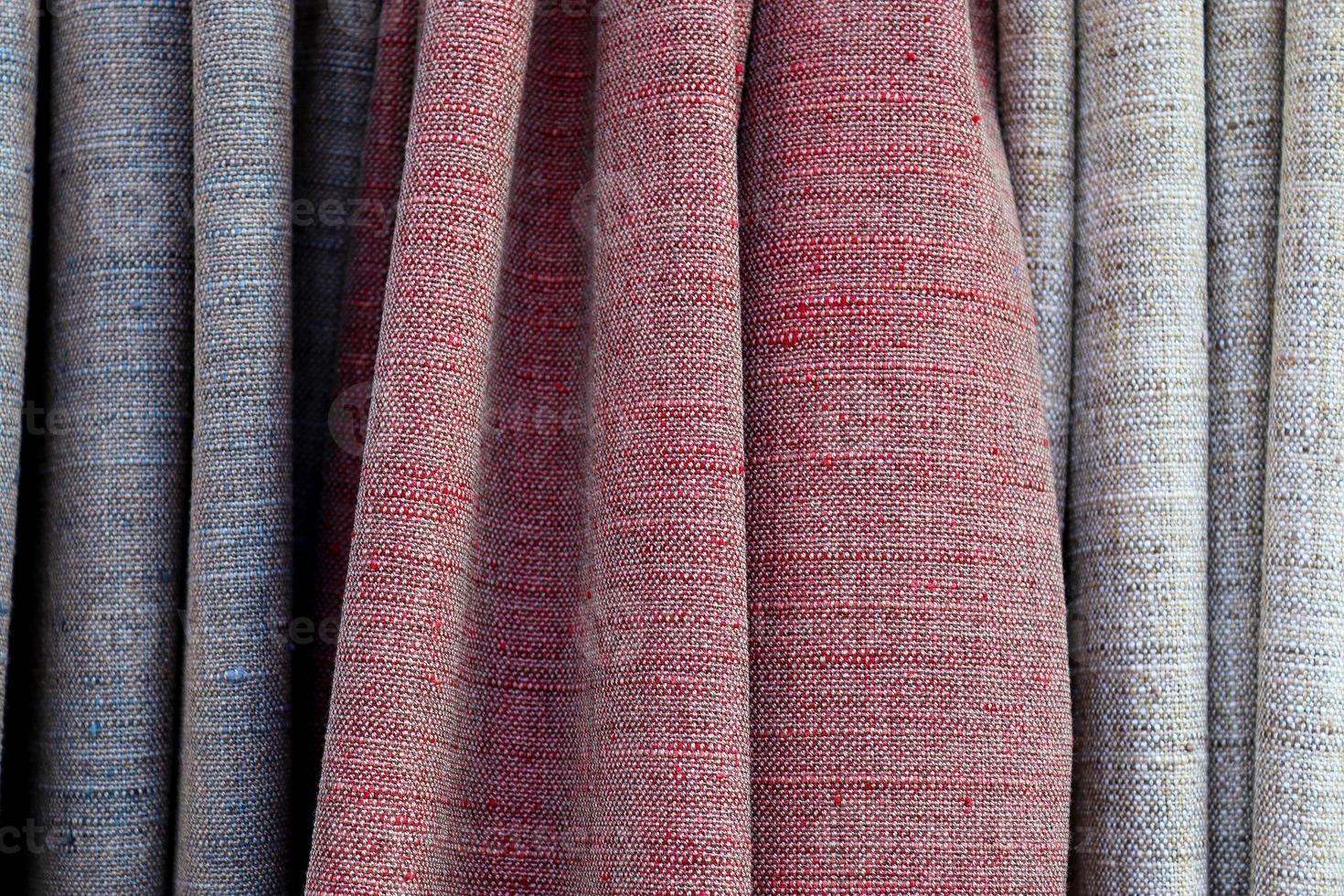 Detailed close up view on samples of cloth and fabrics in different colors found at a fabrics market photo