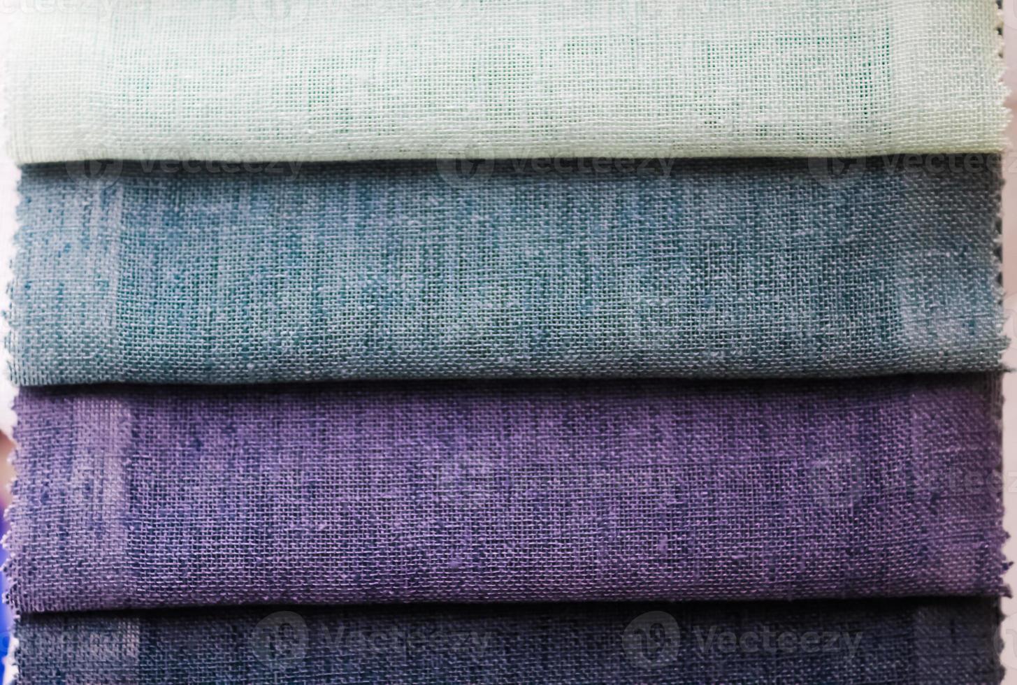 Detailed close up view on samples of cloth and fabrics in different colors found at a fabrics market photo