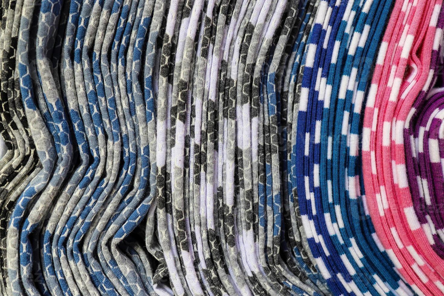 Detailed close up view on samples of cloth and fabrics in different colors found at a fabrics market photo