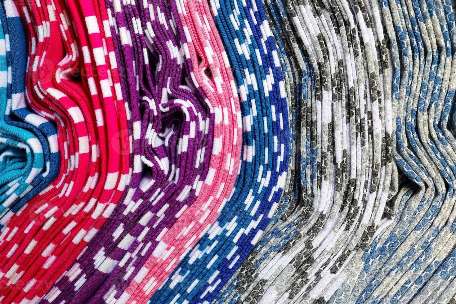 Detailed close up view on samples of cloth and fabrics in different colors found at a fabrics market photo