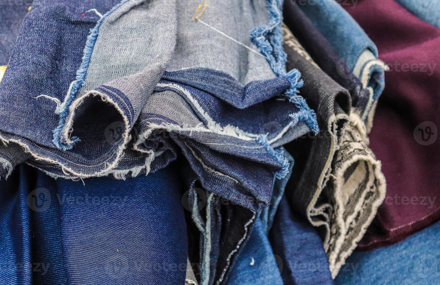 Detailed close up view on samples of cloth and fabrics in different colors found at a fabrics market photo