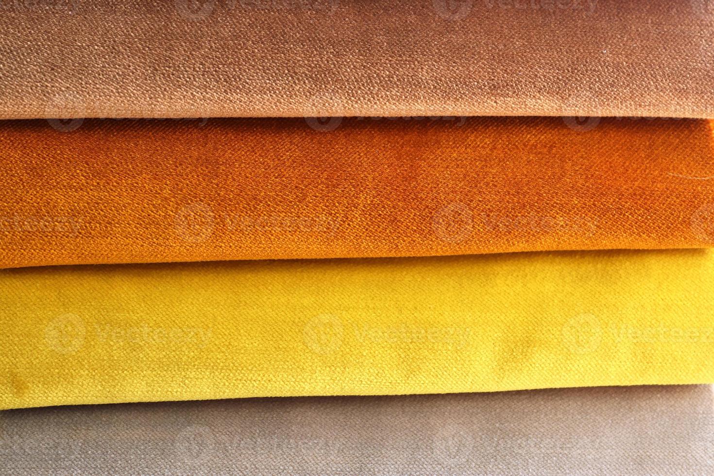 Detailed close up view on samples of cloth and fabrics in different colors found at a fabrics market photo