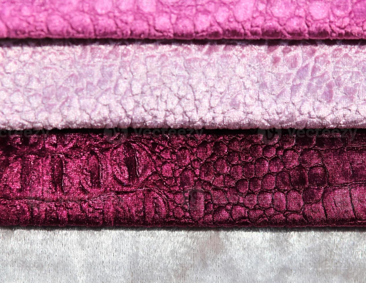 Detailed close up view on samples of cloth and fabrics in different colors found at a fabrics market photo