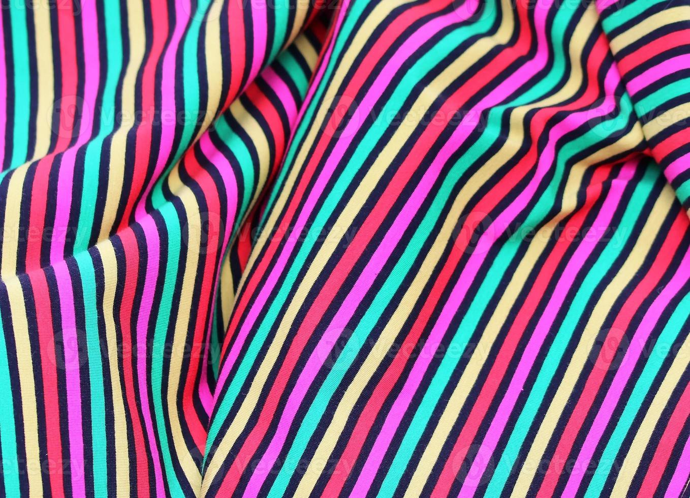 Detailed close up view on samples of cloth and fabrics in different colors found at a fabrics market photo