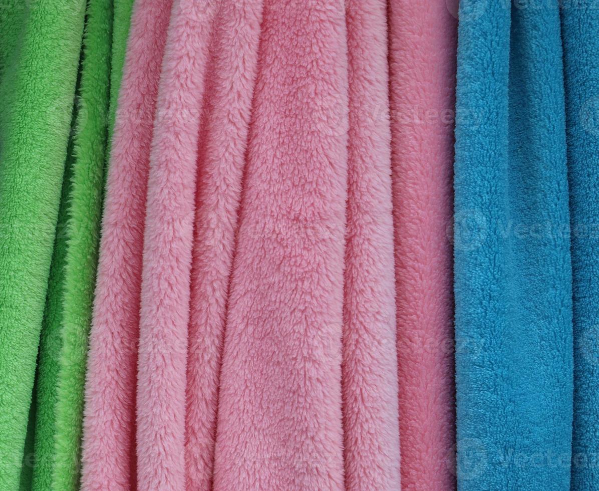 Detailed close up view on samples of cloth and fabrics in different colors found at a fabrics market photo