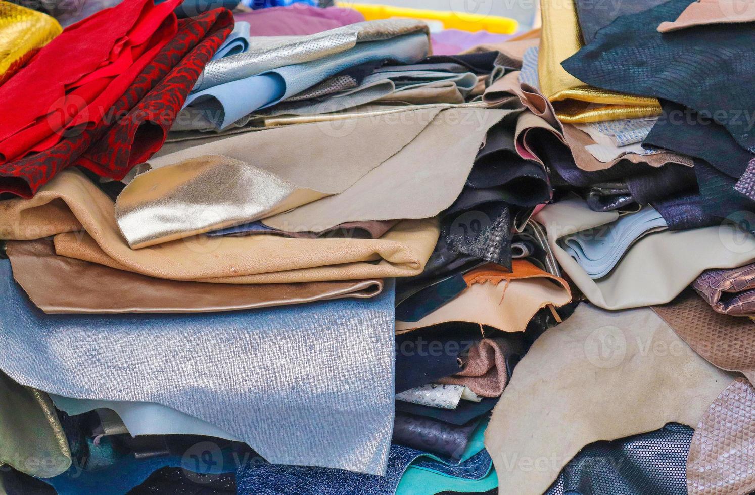 Detailed close up view on samples of cloth and fabrics in different colors found at a fabrics market photo