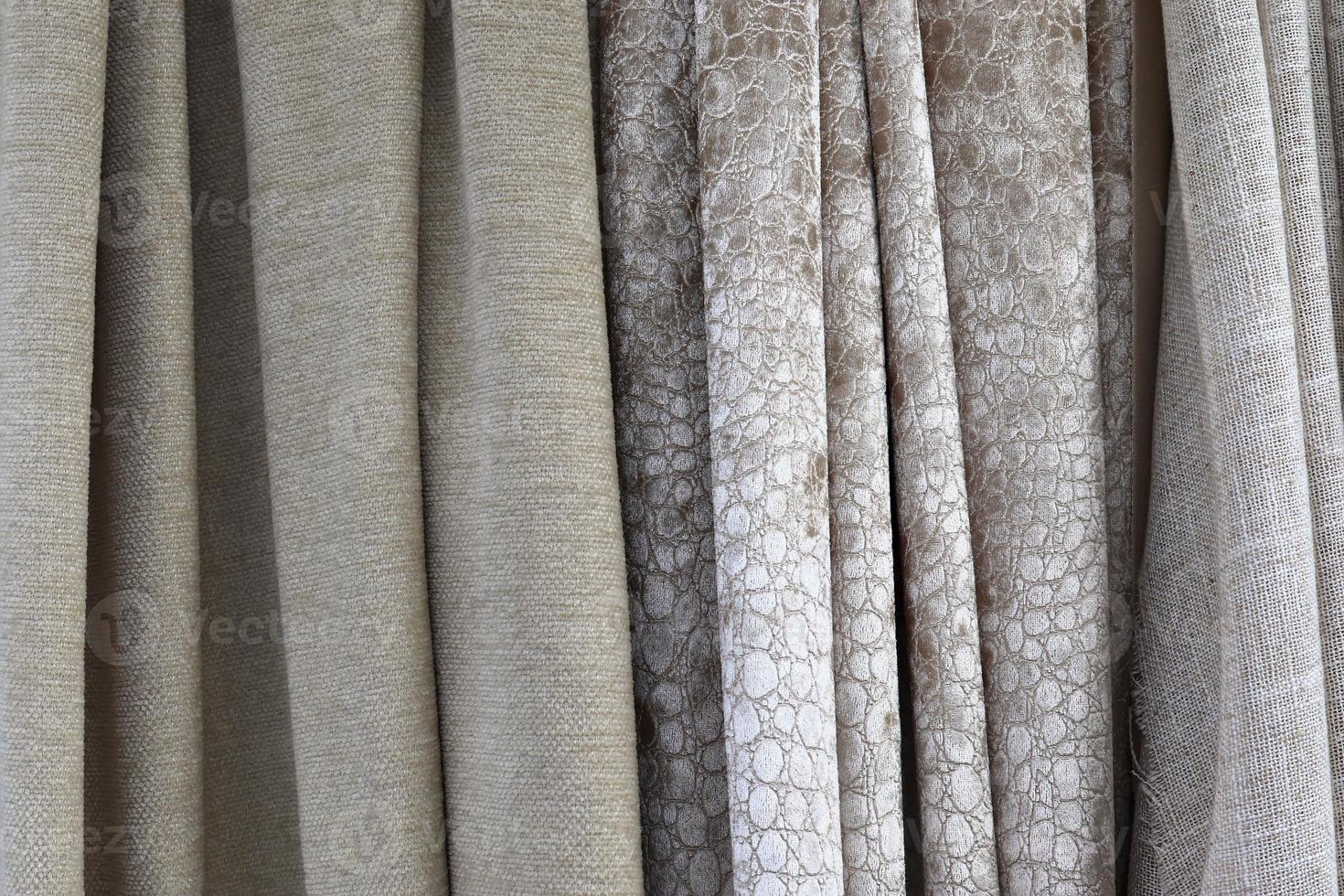 Detailed close up view on samples of cloth and fabrics in different colors found at a fabrics market photo
