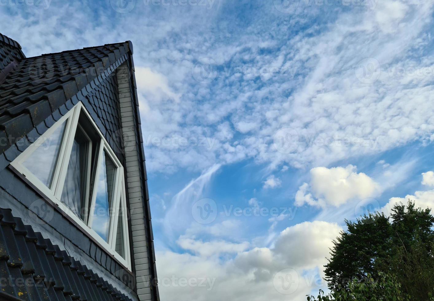 Open roof window in velux style with black roof tiles. photo