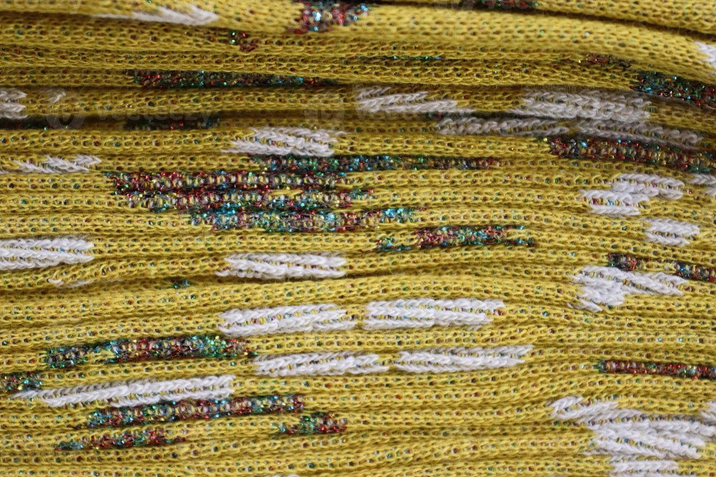 Detailed close up view on samples of cloth and fabrics in different colors found at a fabrics market photo