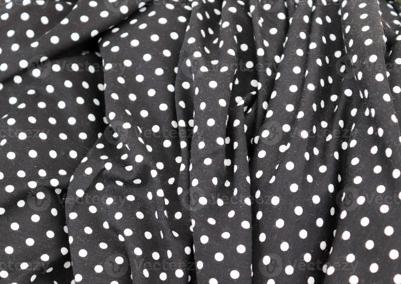 Detailed close up view on samples of cloth and fabrics in different colors found at a fabrics market photo