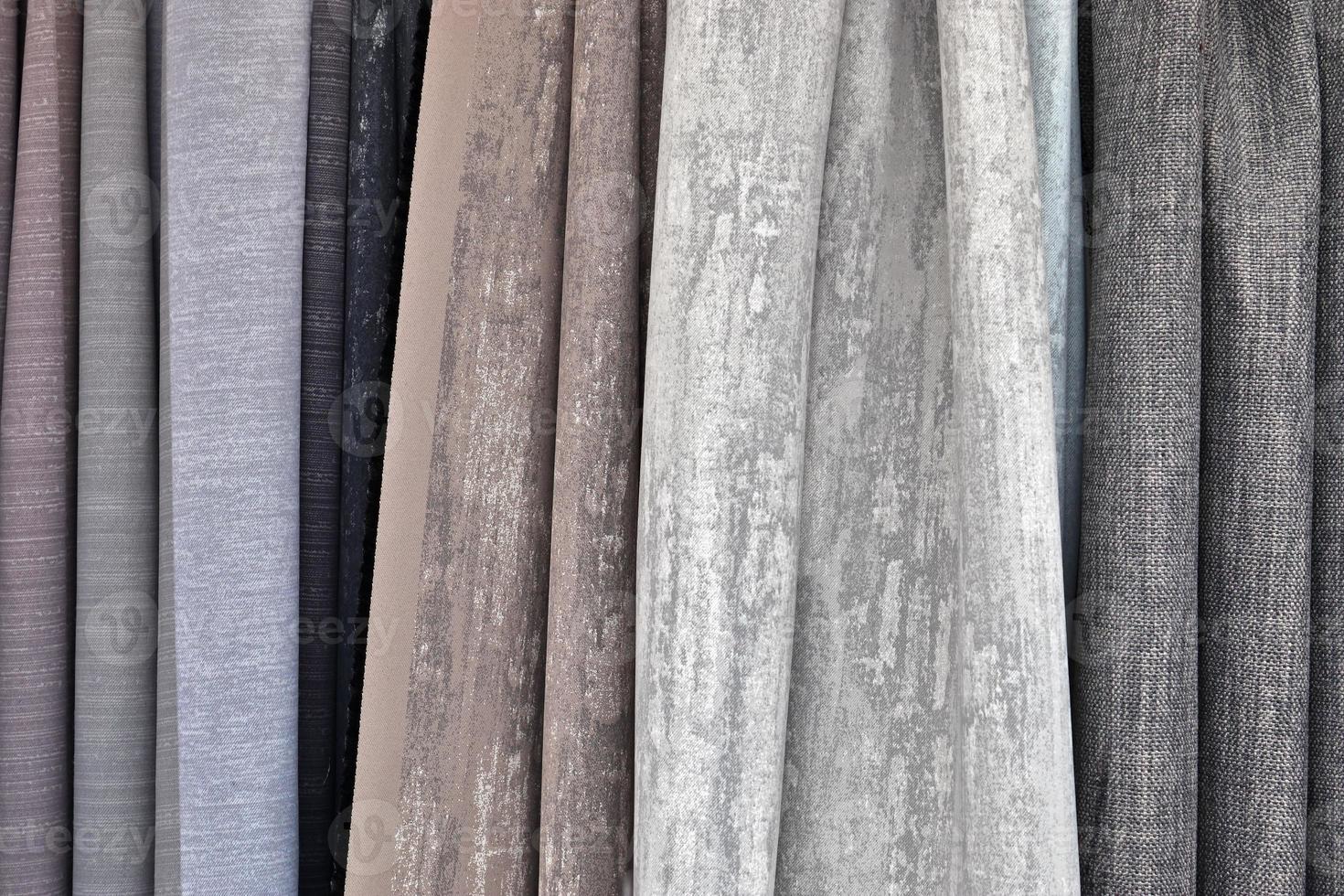 Detailed close up view on samples of cloth and fabrics in different colors found at a fabrics market photo