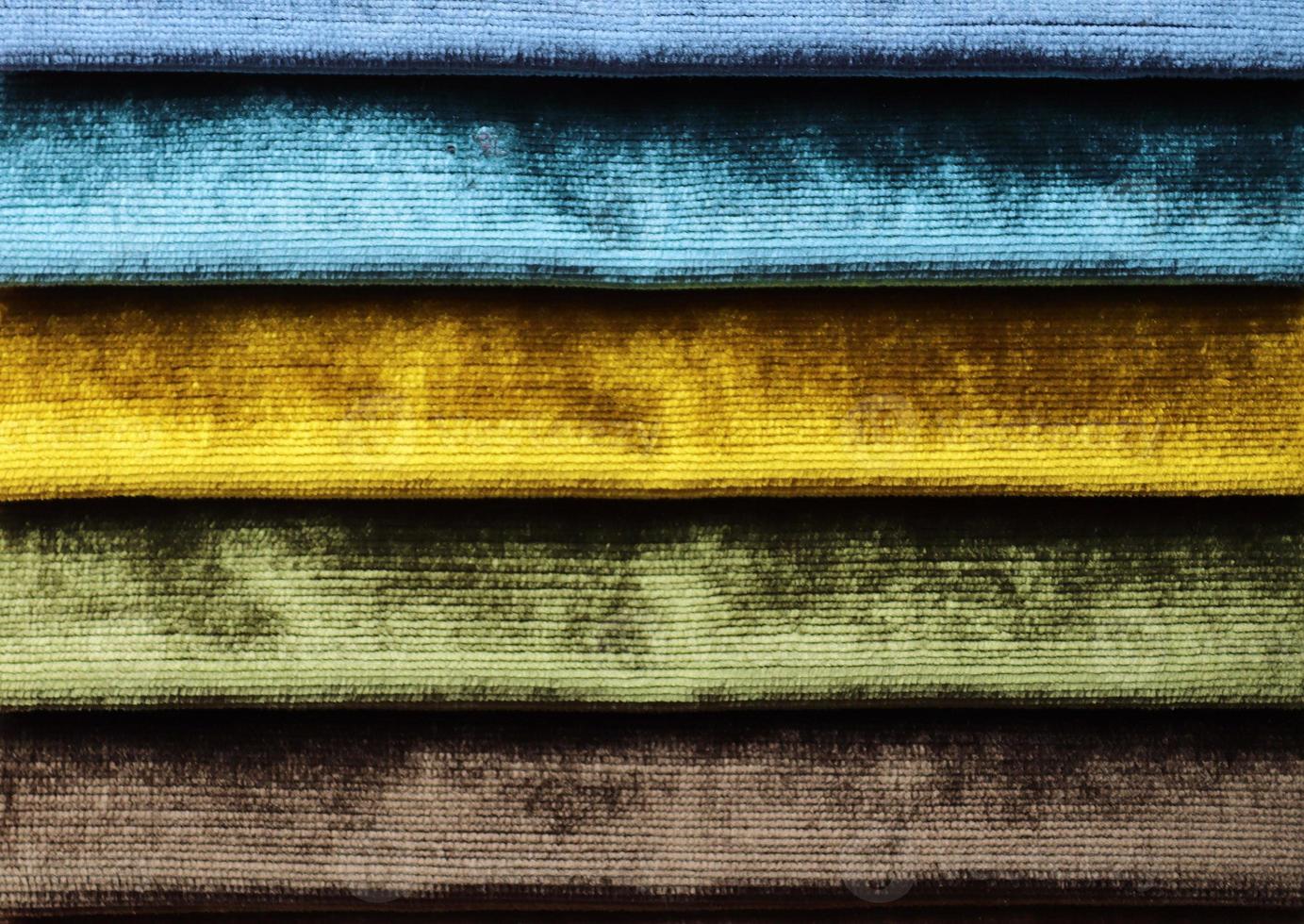 Detailed close up view on samples of cloth and fabrics in different colors found at a fabrics market photo