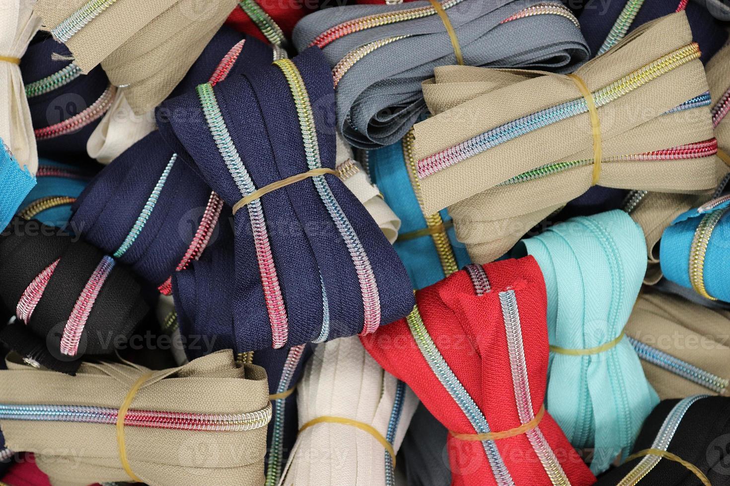 Detailed close up view on samples of cloth and fabrics in different colors found at a fabrics market photo