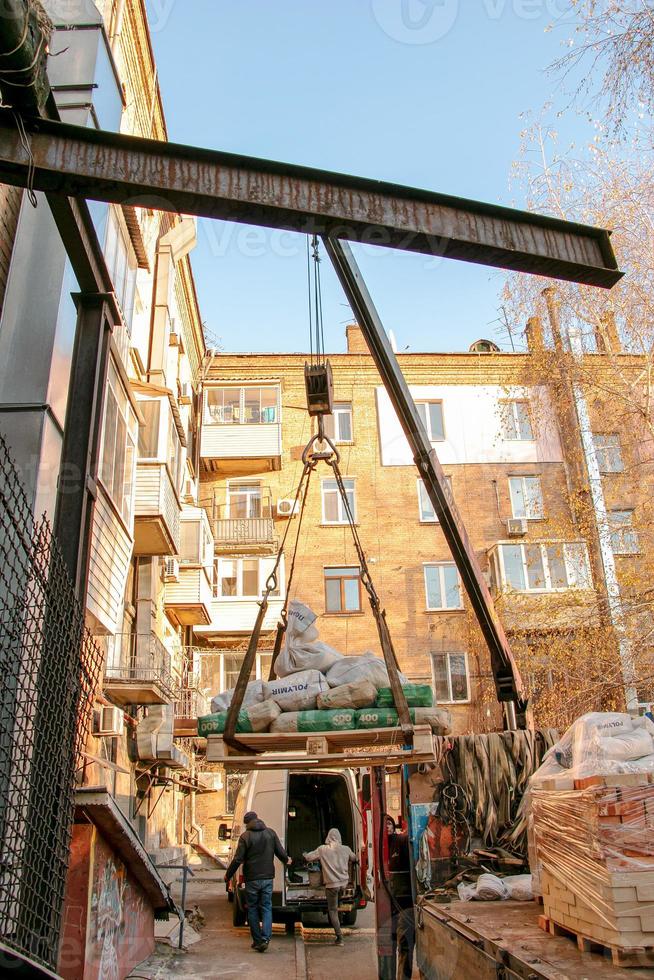 Loading sandbags for the renovation of an apartment in a five-story building. photo