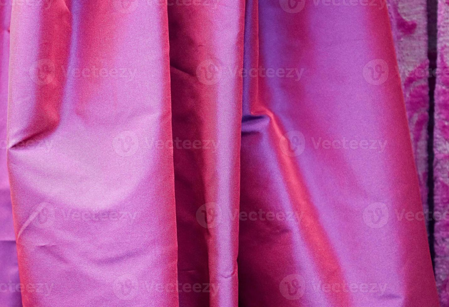 Detailed close up view on samples of cloth and fabrics in different colors found at a fabrics market photo