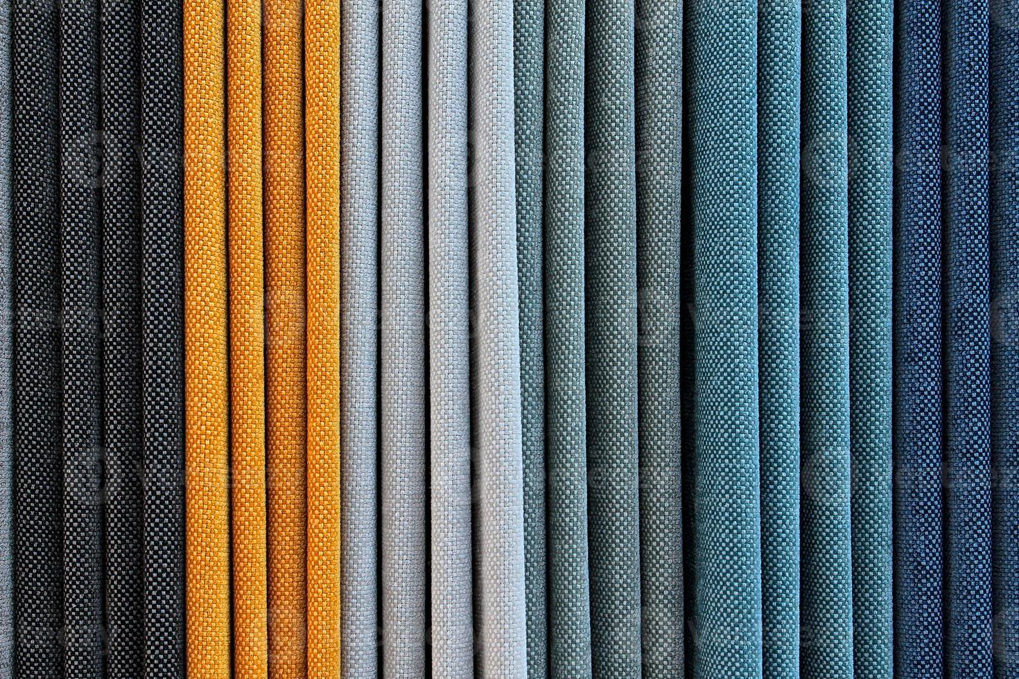 Detailed close up view on samples of cloth and fabrics in different colors found at a fabrics market photo