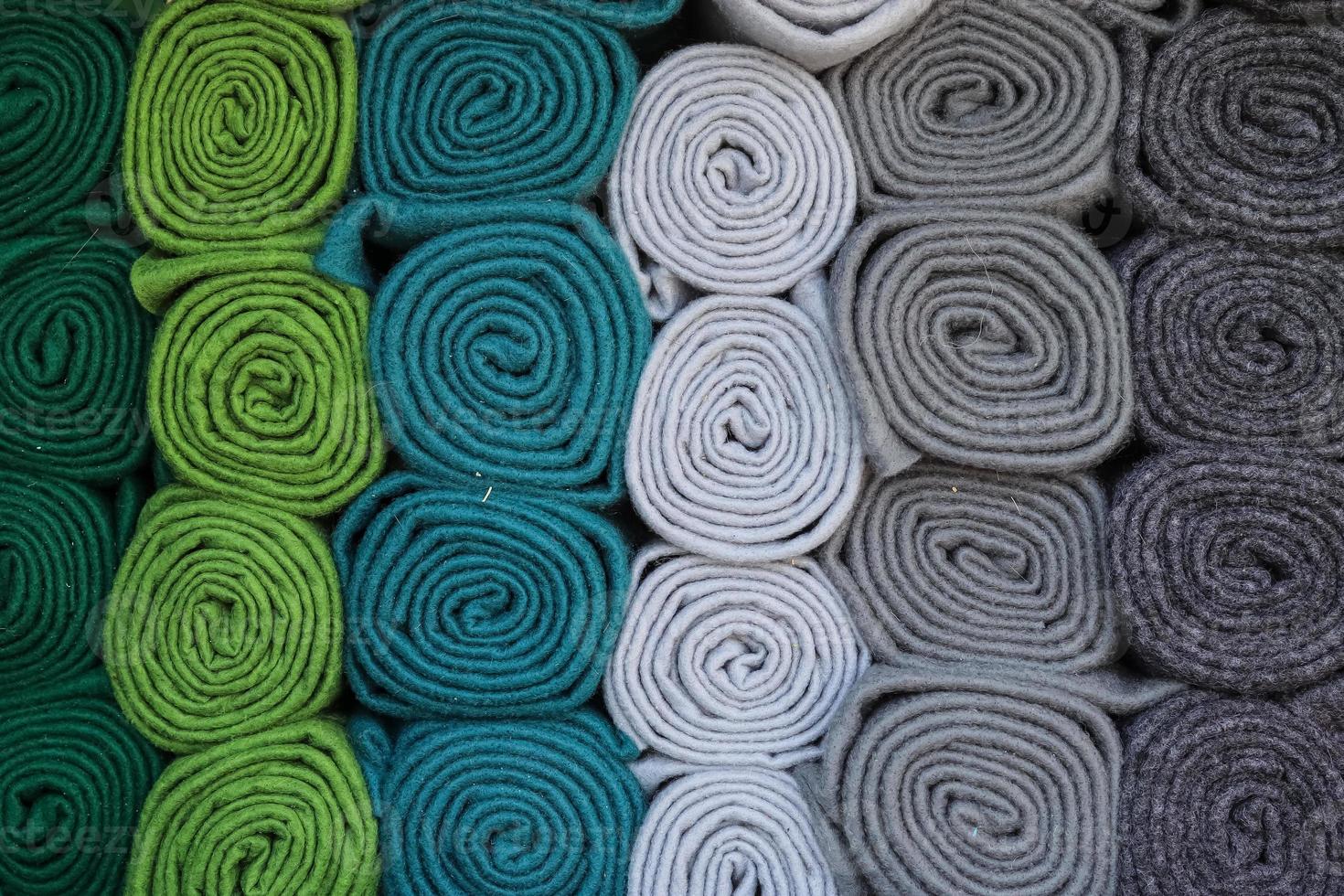 Detailed close up view on samples of cloth and fabrics in different colors found at a fabrics market photo